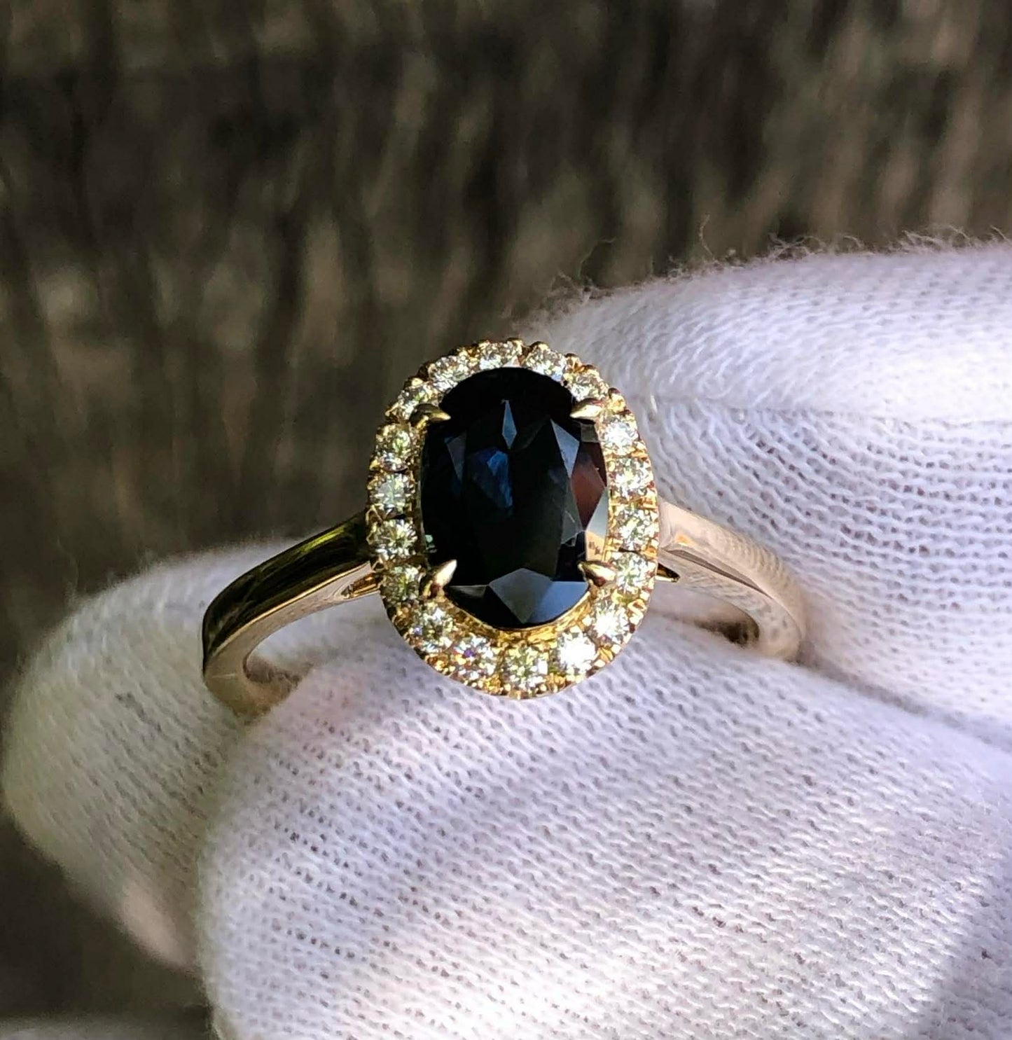 Rich Blue Oval Sapphire and Diamond Halo 9ct Yellow Gold Ring. M92279
