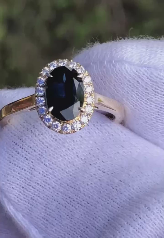 Rich Blue Oval Sapphire and Diamond Halo 9ct Yellow Gold Ring. M92279